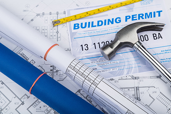 Building permits, plans and a hammer