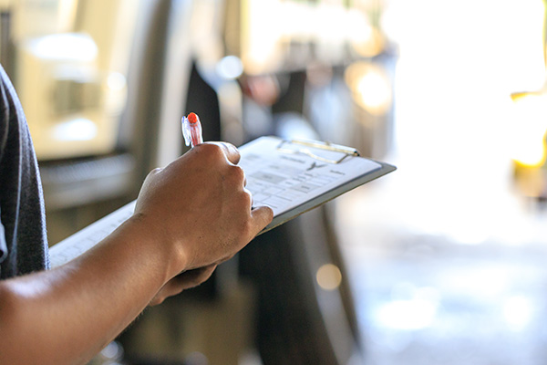 Person holding a clipboard doing an inspection