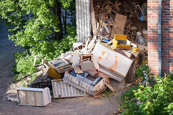 Trash and junk overflows from a garage.