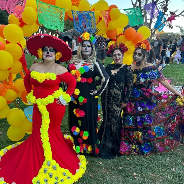 Image of 4 people dressed up for in Halloween costumes.