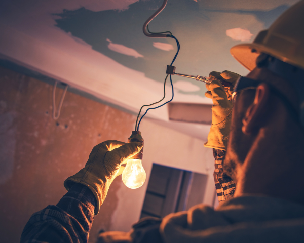 Image of a person doing electrical work.